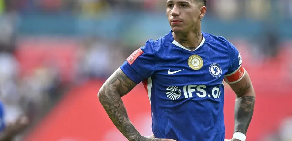 Player in blue jersey with tattoos on field