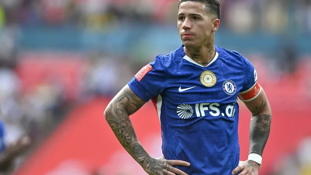 Player in blue jersey with tattoos on field