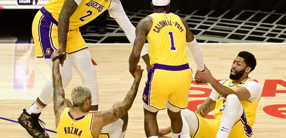 Lakers players helping teammates on the court