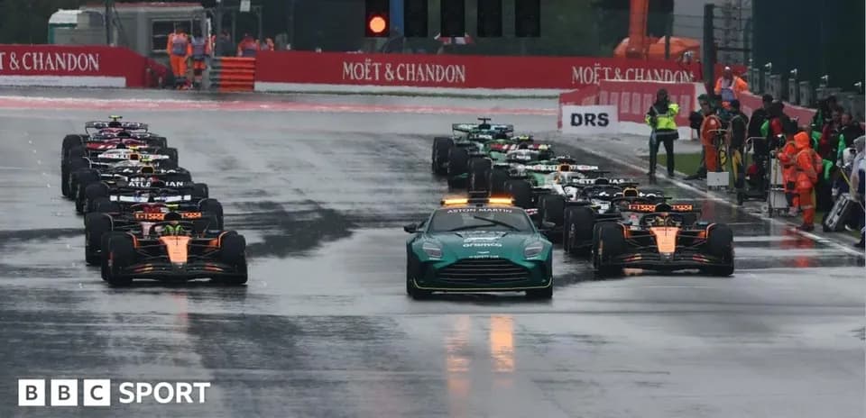 Cars lined up on wet track before race start