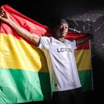 Player holding a flag with red, yellow, and green stripes