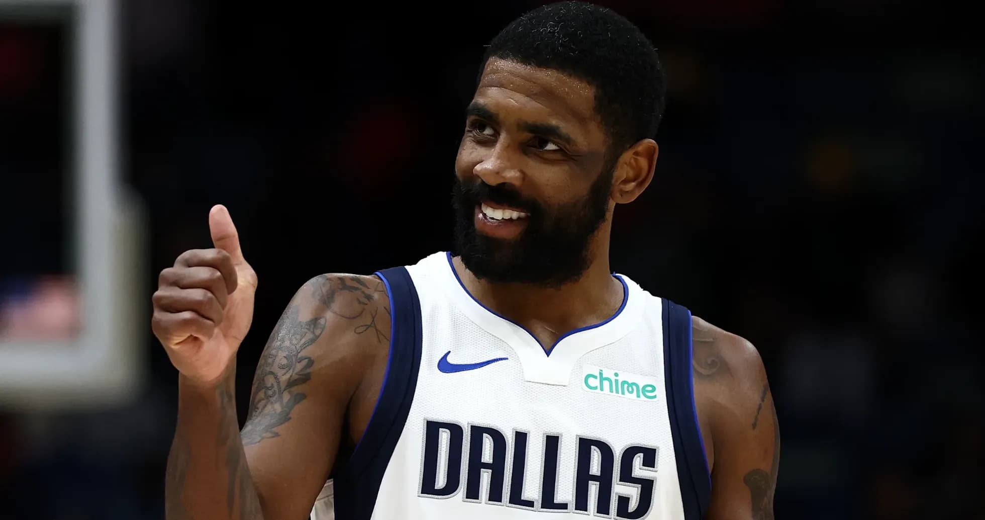 Player giving thumbs up in Dallas Mavericks jersey