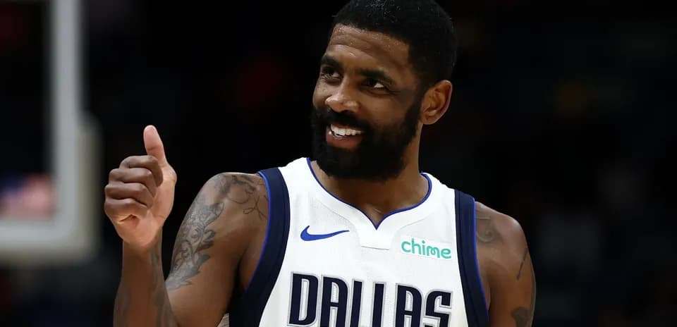 Player giving thumbs up in Dallas Mavericks jersey