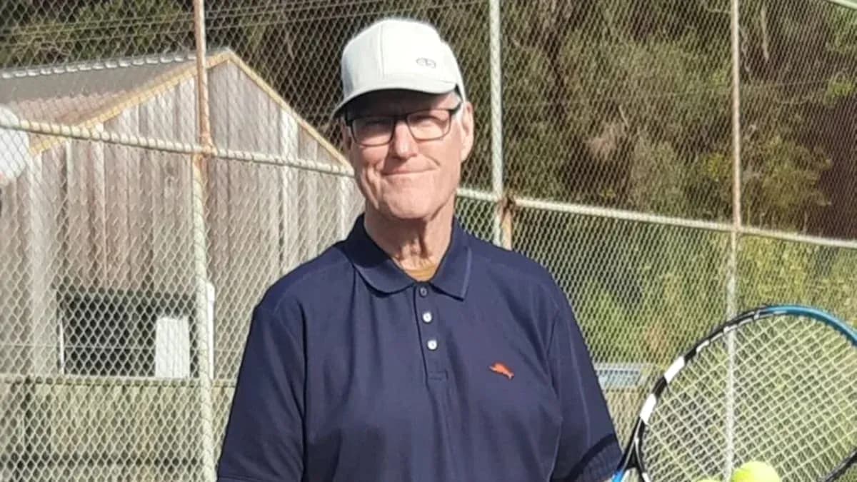 Man holding a tennis racket on court