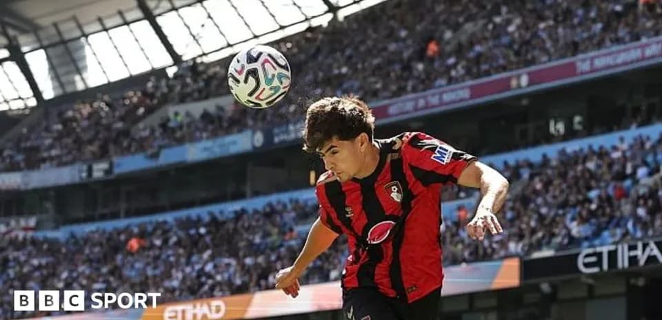 Bournemouth player heading ball during match at Etihad