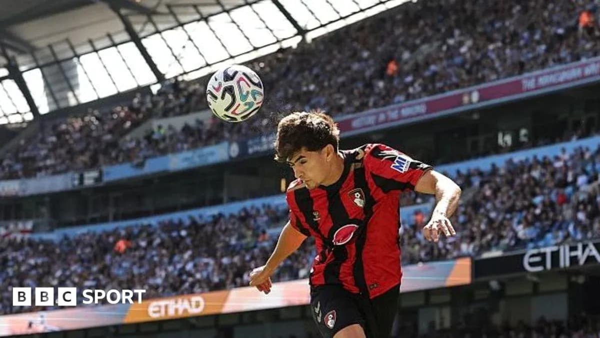 Bournemouth player heading ball during match at Etihad