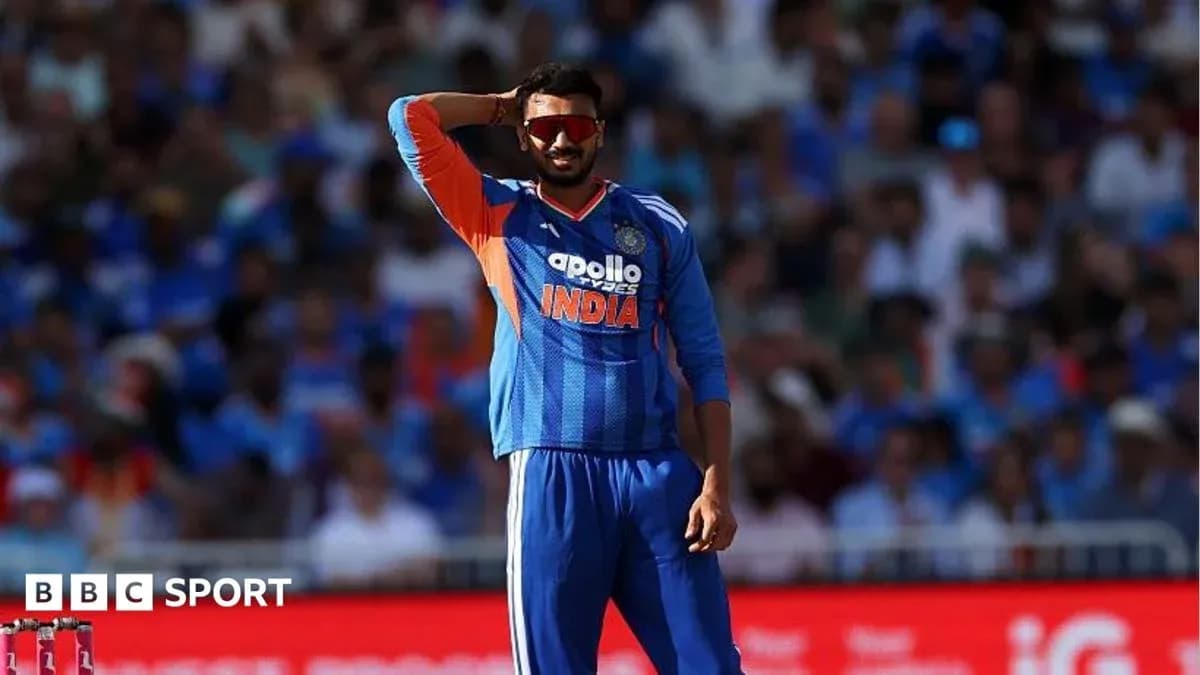 Cricketer in India jersey signaling during match