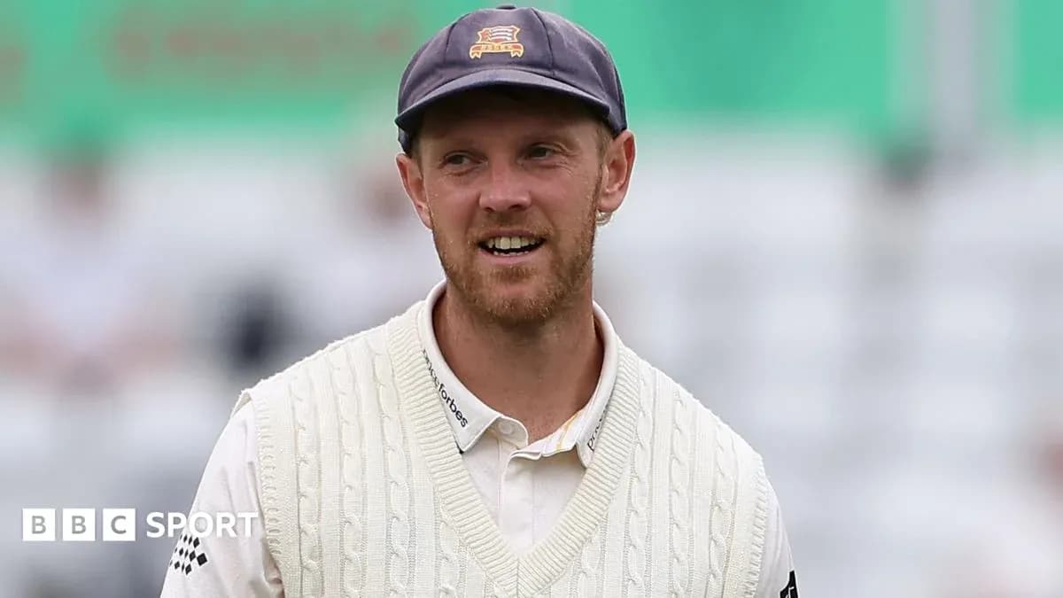 Cricketer in white sweater during match