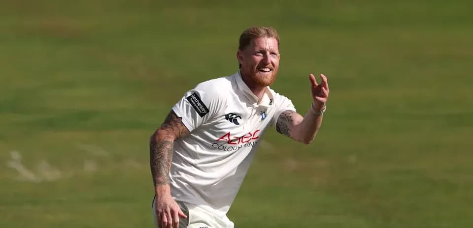 Cricketer preparing to catch a ball on field