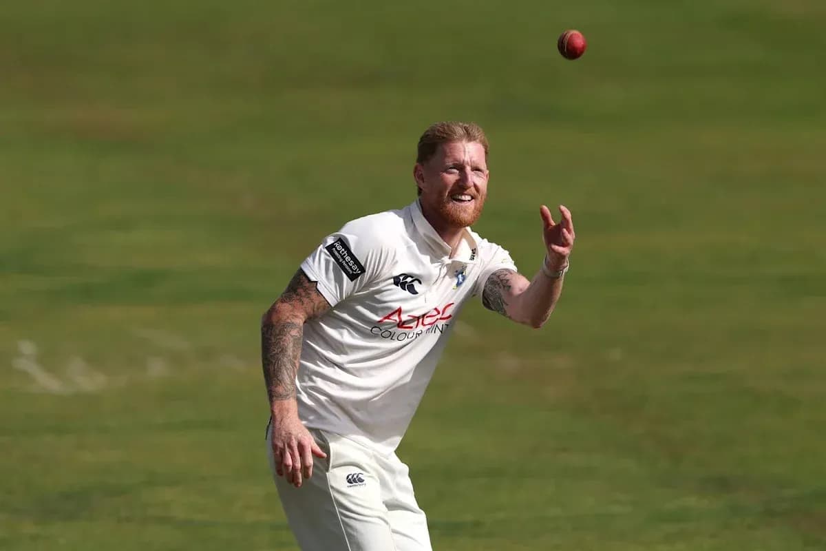 Cricketer preparing to catch a ball on field