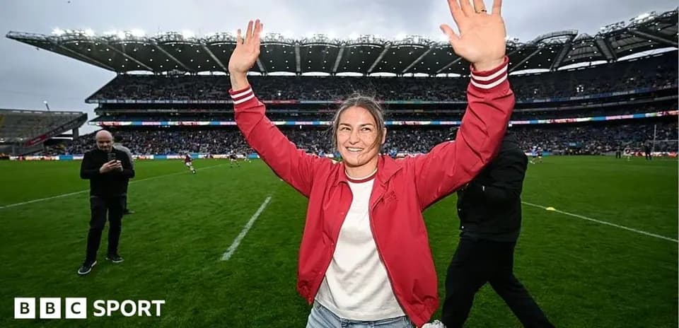 Woman celebrating on the rugby field with raised hands
