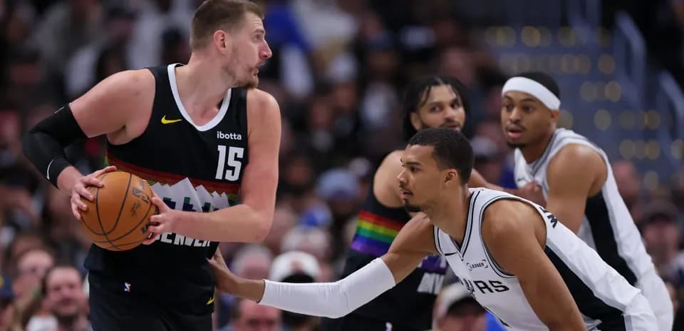 Player dribbling ball while being guarded during game