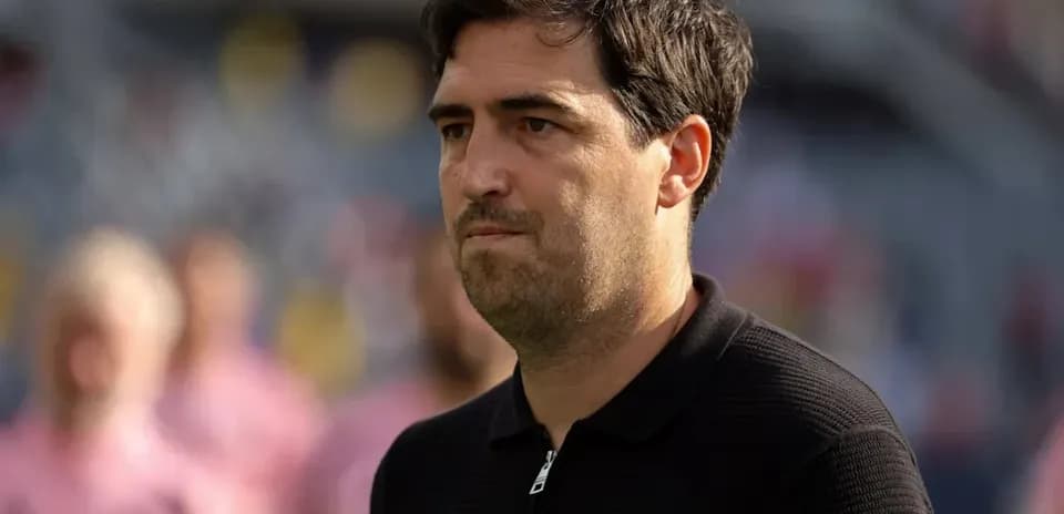 Coach observing players during pre-match warm-up