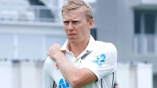 Cricketer adjusting his shirt on the field