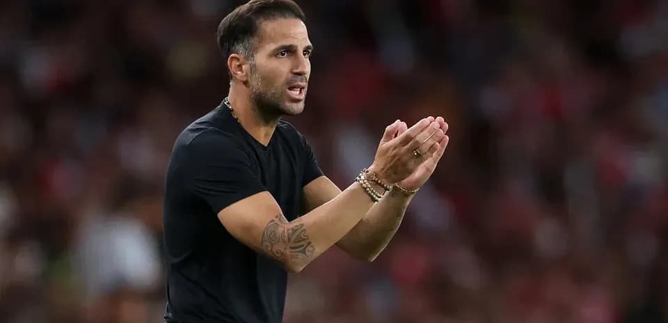 Coach gesturing during a football match on sidelines