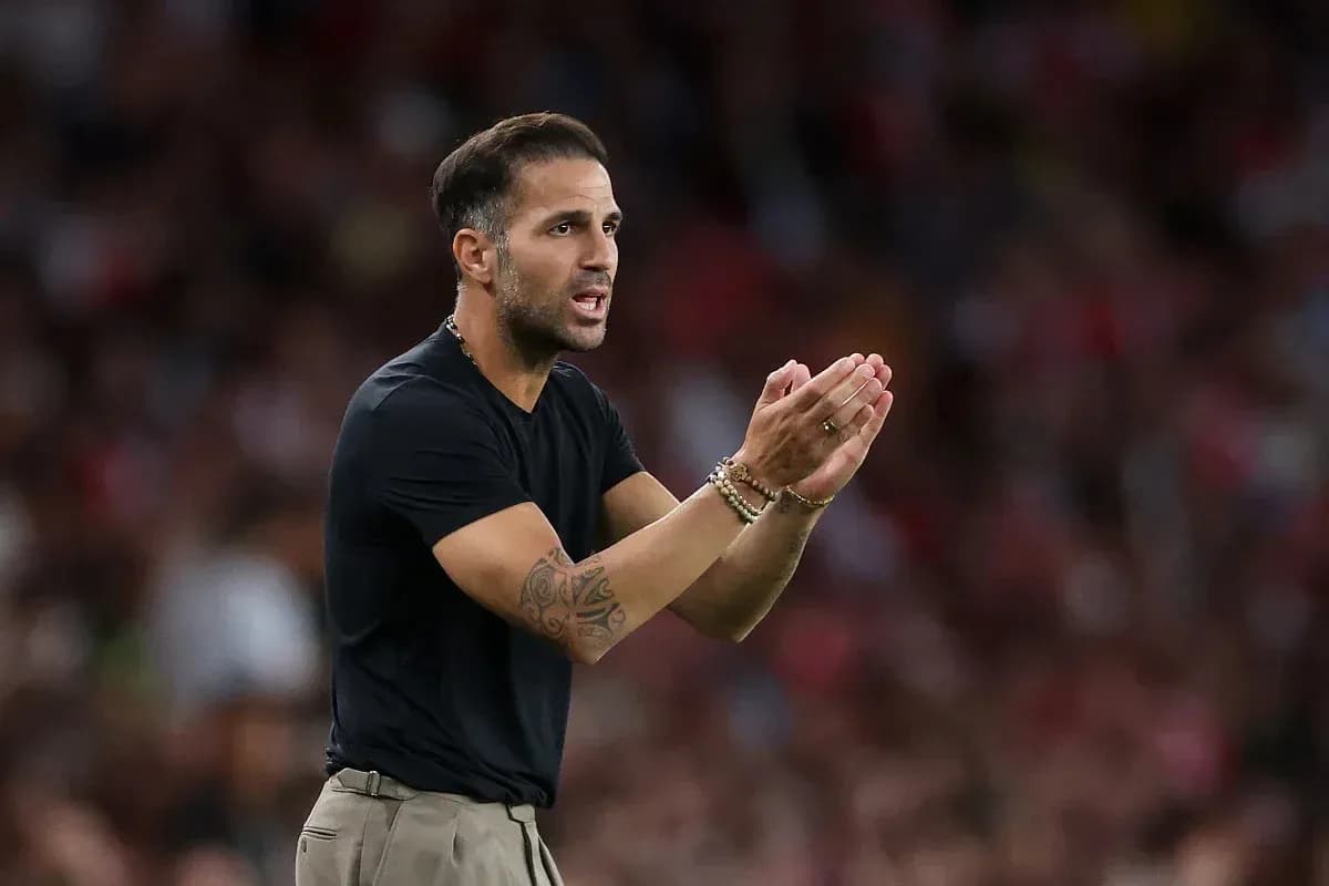 Coach gesturing during a football match on sidelines