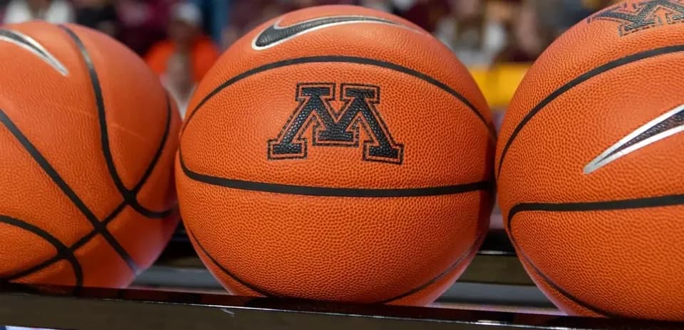 Three basketballs with Minnesota logo on display