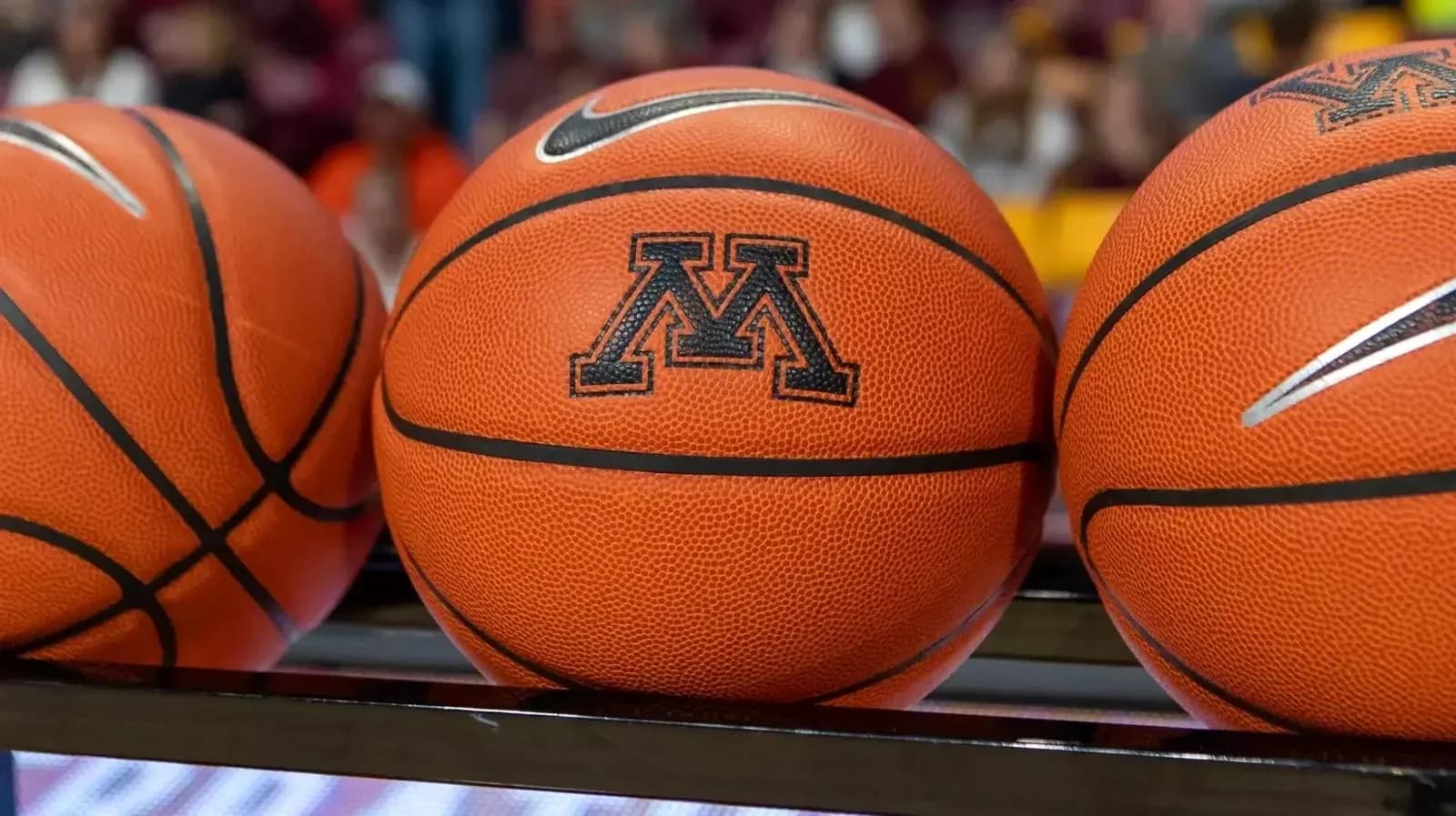 Three basketballs with Minnesota logo on display