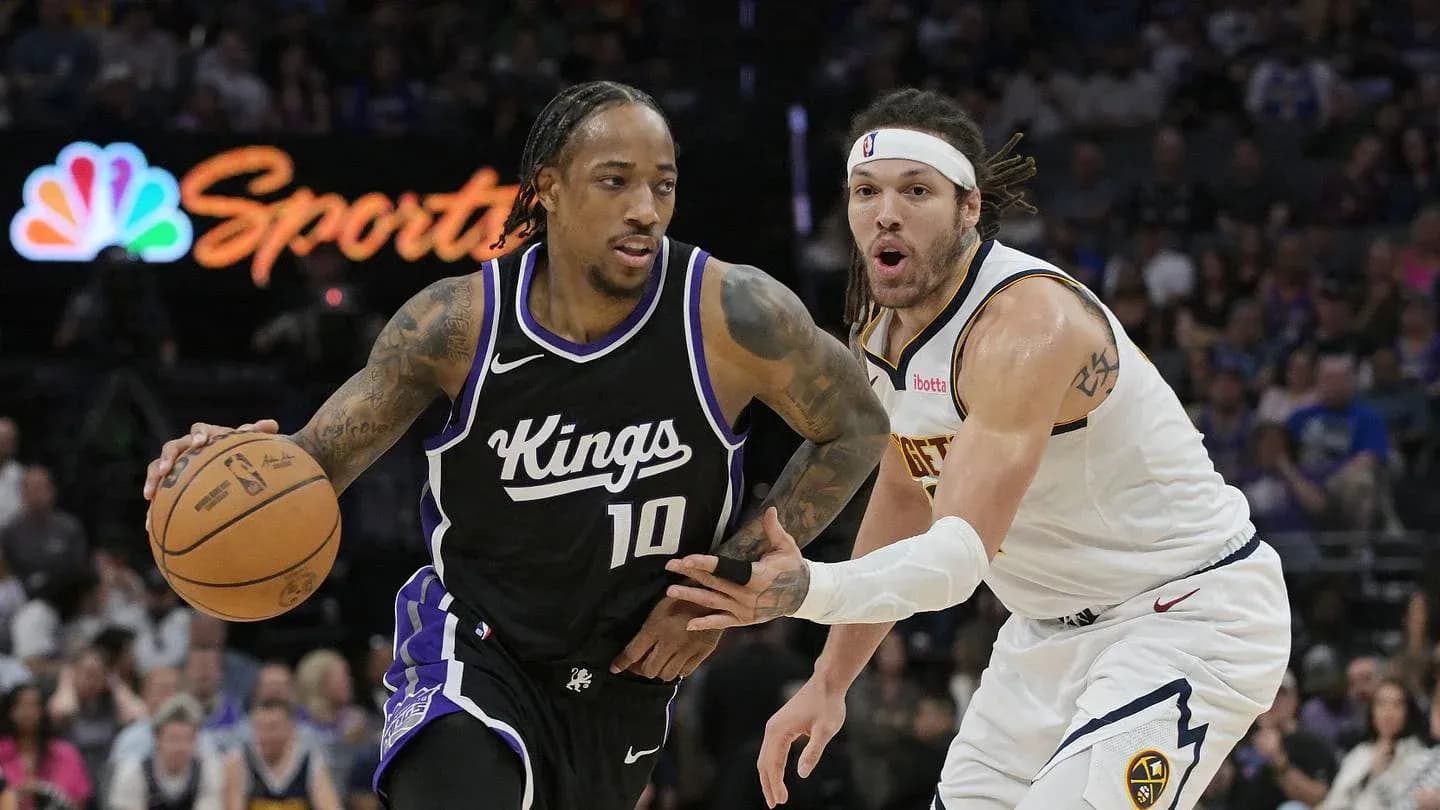 Player dribbling basketball with defender closely behind