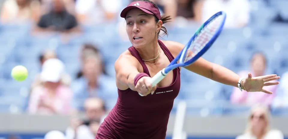 Female tennis player returning a serve on court