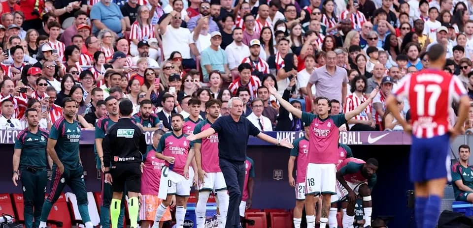 Coaching staff and players on the sidelines during match