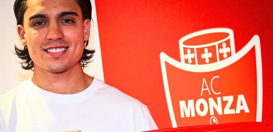 Player holding AC Monza jersey during signing ceremony