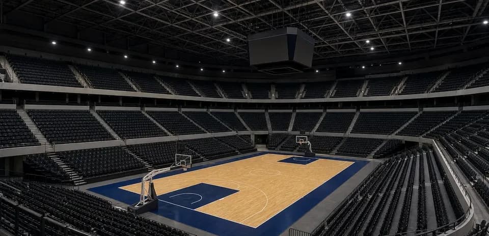 Empty basketball arena with court and bleachers