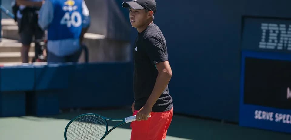 Tennis player preparing to serve on court