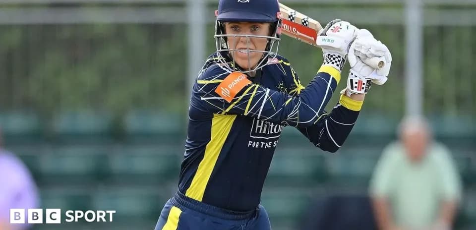 Cricketer preparing to bat in a match