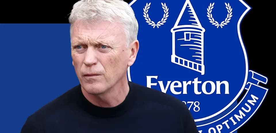 Manager with Everton logo in background