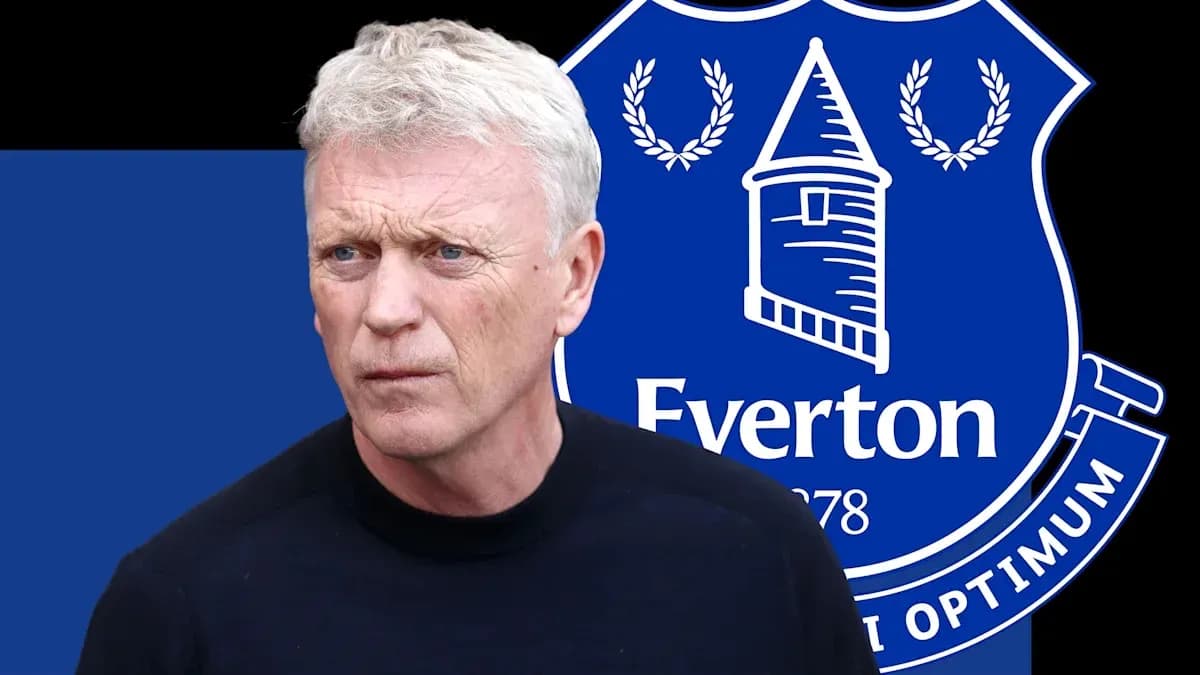 Manager with Everton logo in background