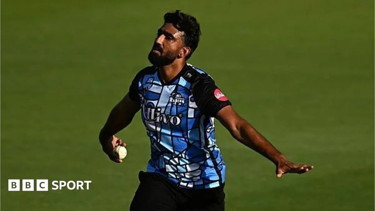 Cricketer bowling with ball during match