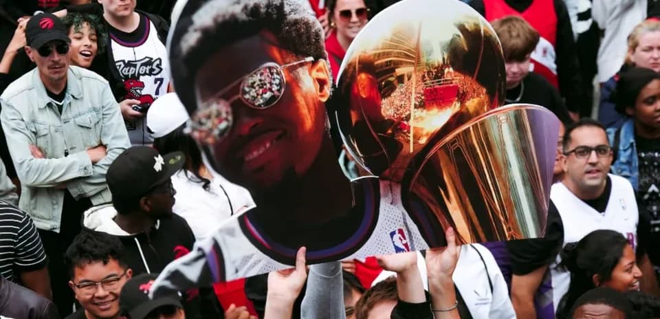 Fans celebrating with trophy and player cutout