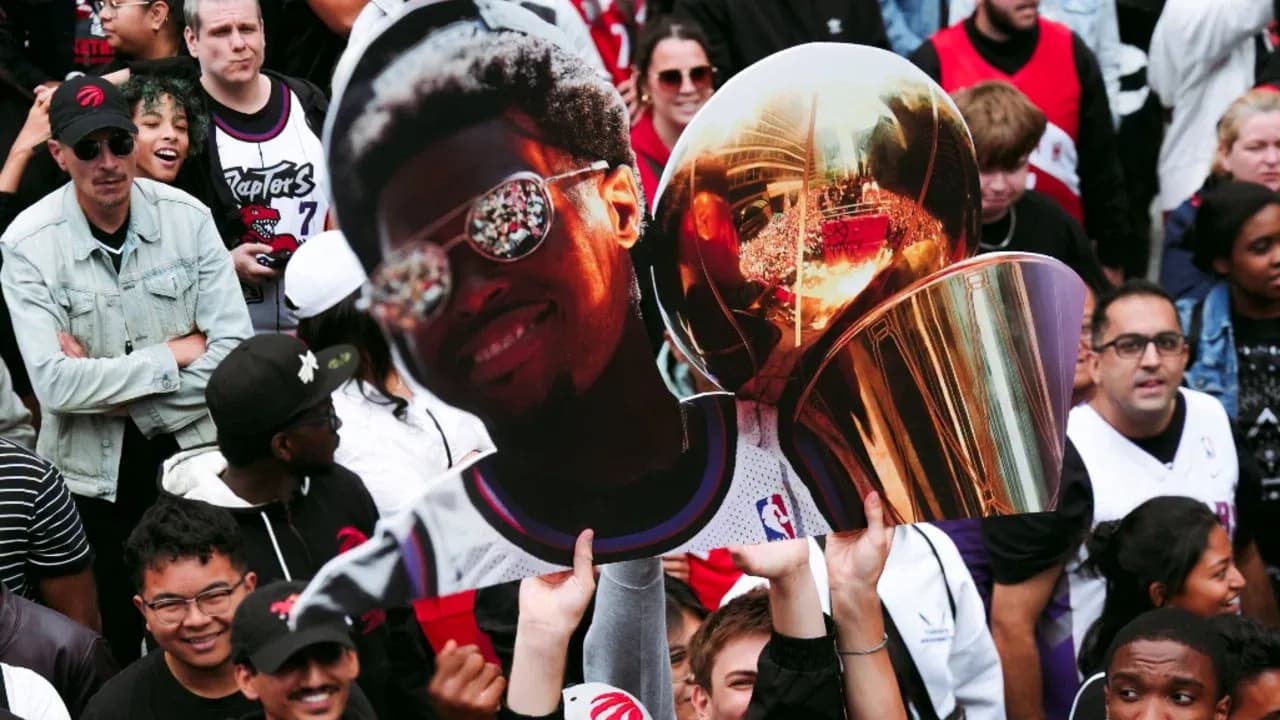 Fans celebrating with trophy and player cutout
