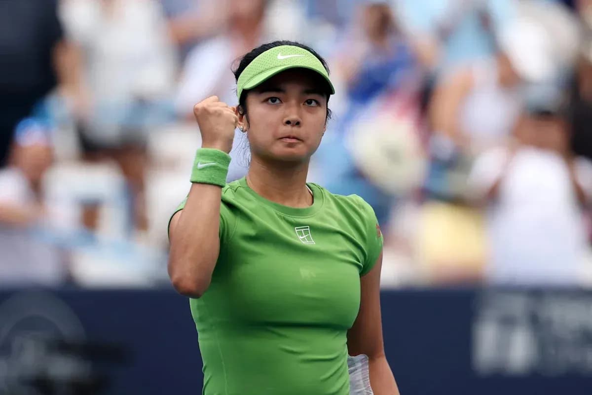 Tennis player celebrating victory with raised fist