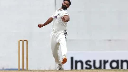 Bowler delivering a ball during cricket match