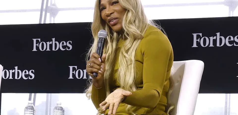Speaker discussing at Forbes event with microphone