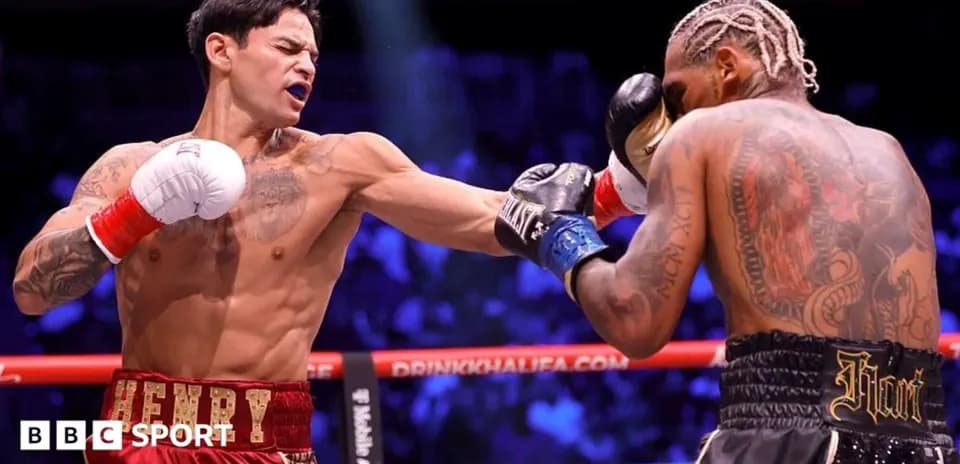 Boxer throwing punch during match in ring