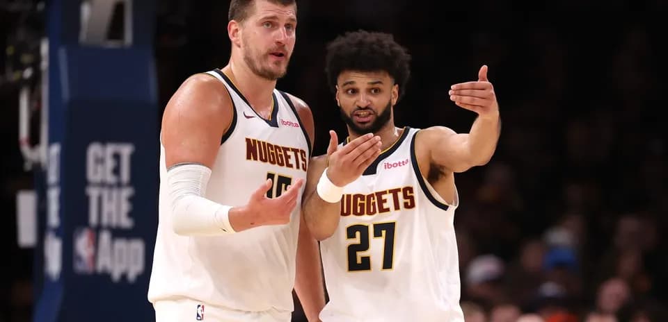 Two Denver Nuggets players discussing during game