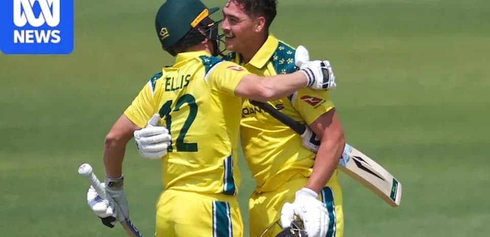 Two Australian cricketers celebrating a run together