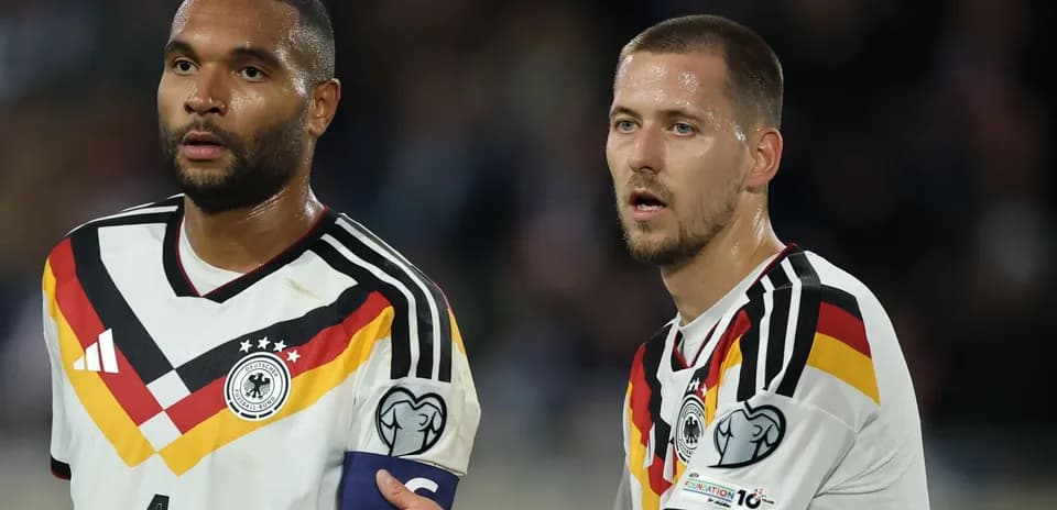 Two German players discussing on the field