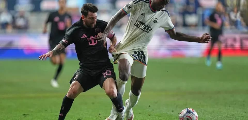 Lionel Messi battling for the ball with opponent
