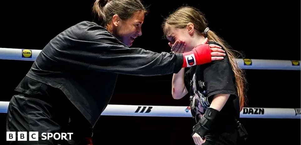 Boxer mentoring young girl in the ring