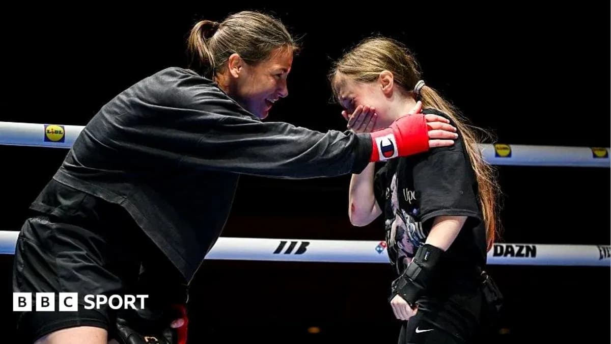 Boxer mentoring young girl in the ring