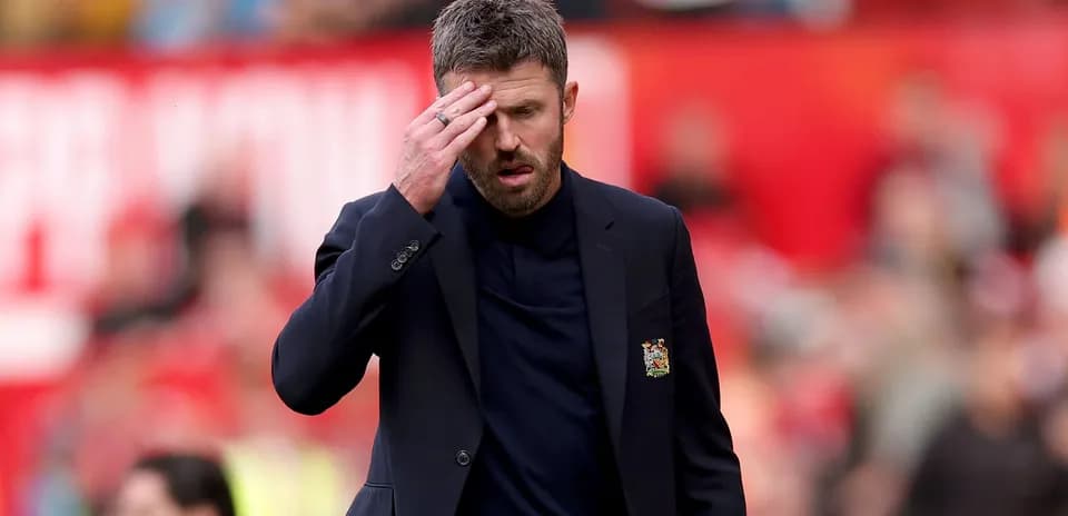 Manager walking with hand on forehead during match