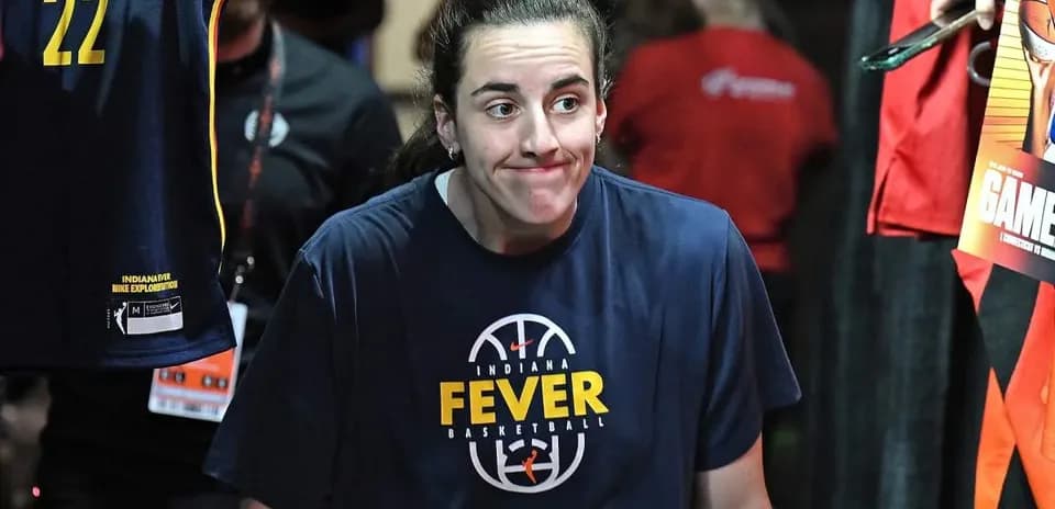 Player in Indiana Fever shirt entering arena