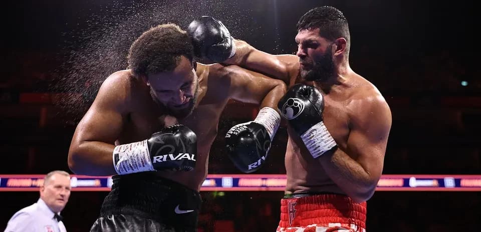 Boxers exchanging punches in a boxing match