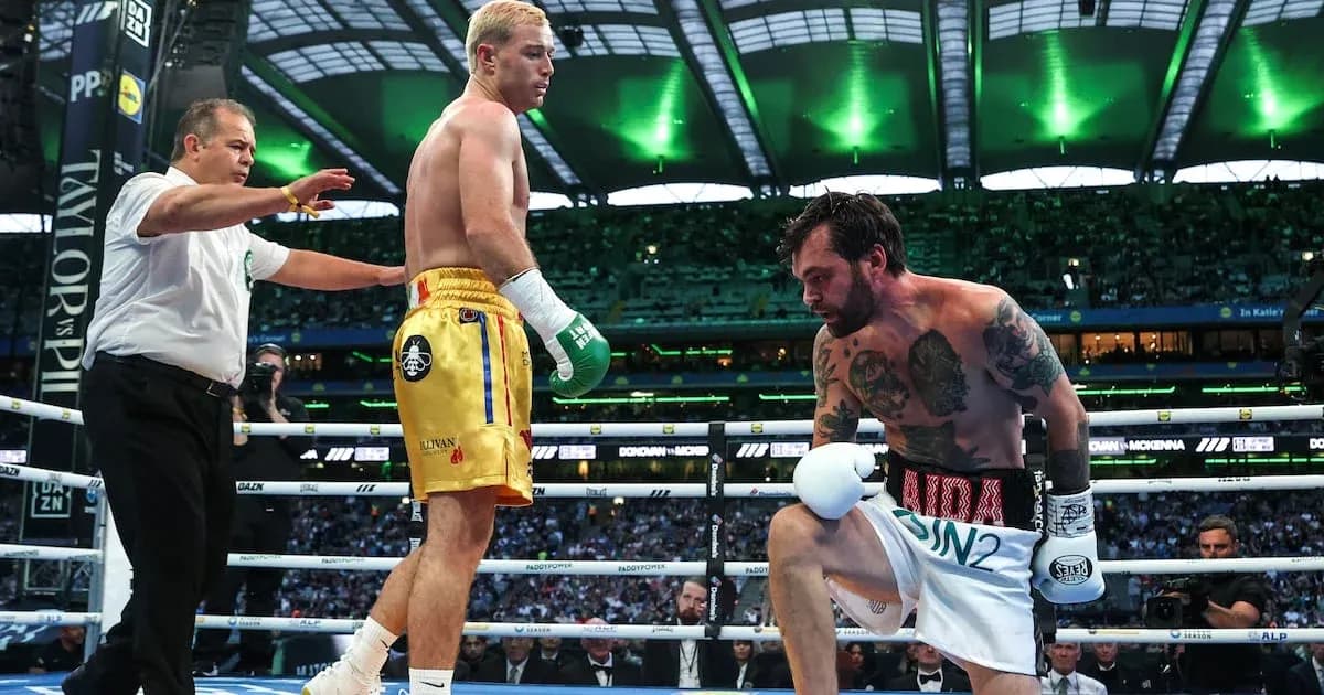 Boxers in ring with referee during match