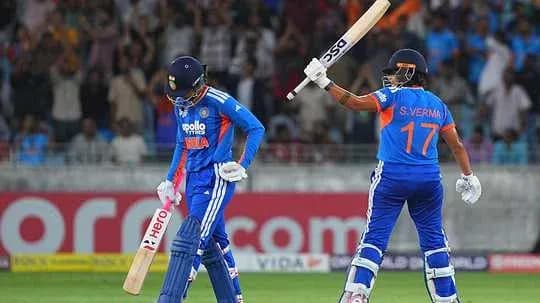 Two cricket players on the field during match