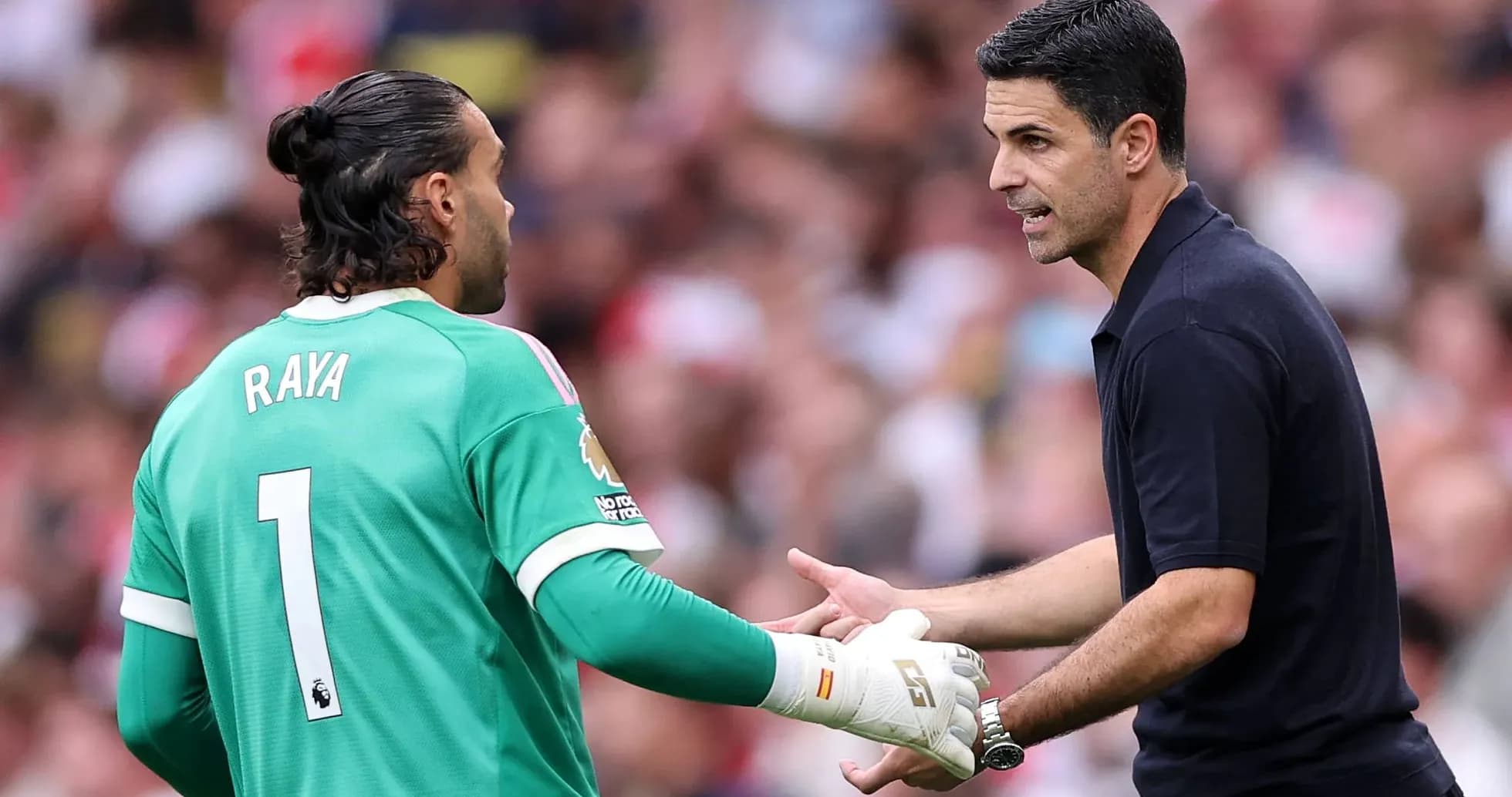 Goalkeeper Raya receiving instructions from coach Arteta